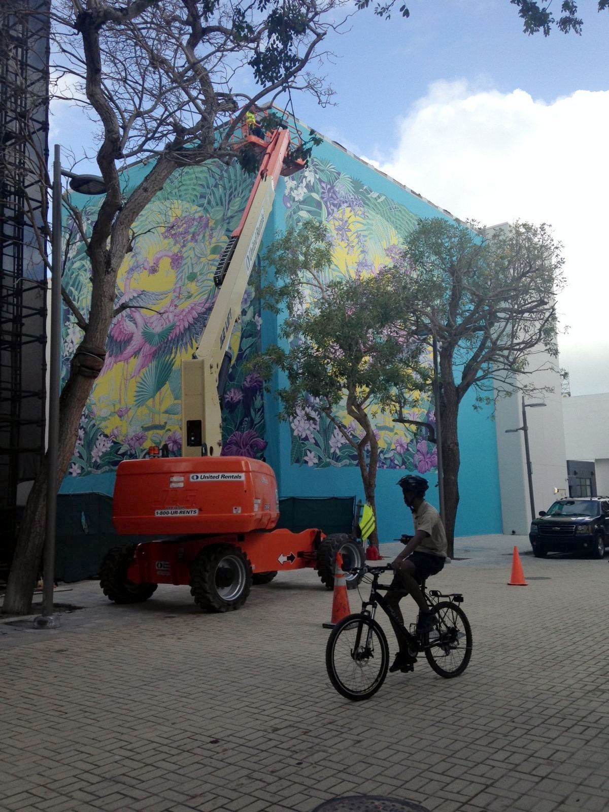 Large-format tropical mural installation by boom lift